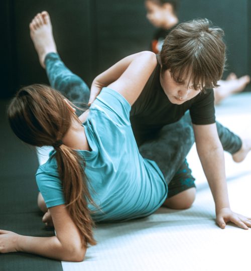 Kids grappling on mats at Team Taino Martial Arts